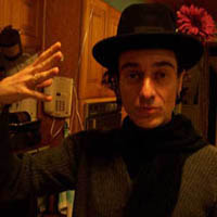 Henry Manett awith a hat and flower